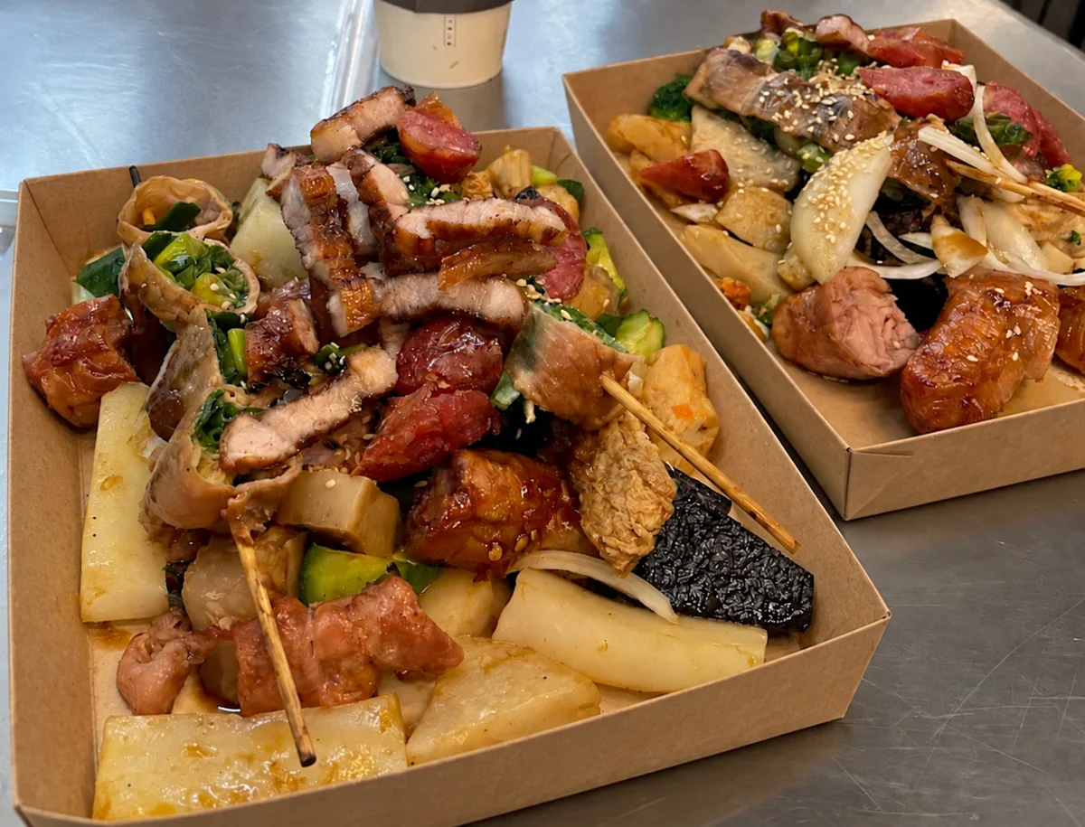 刷上醬料後的串燒與小吃餐盒